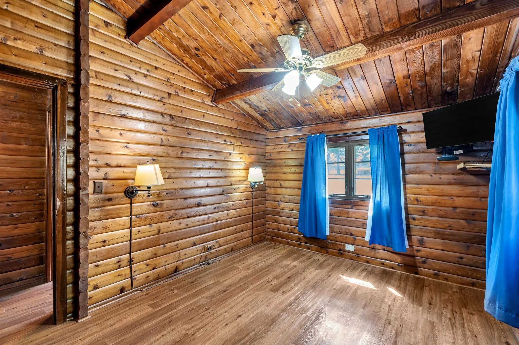 Bedroom featuring wood finished floors, a ceiling fan, and wood ceiling