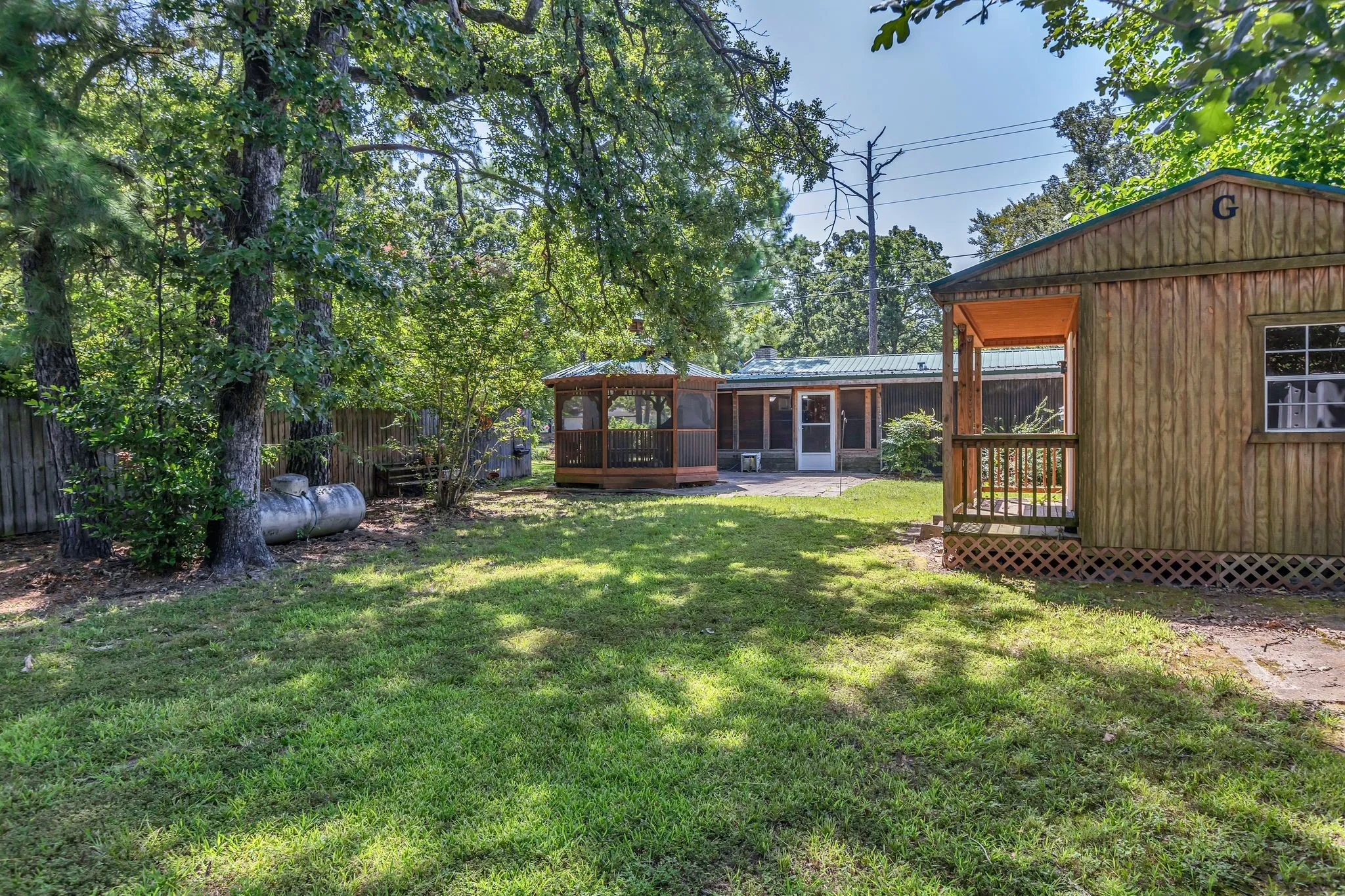 View of grassy yard with outbuilding and gazebo