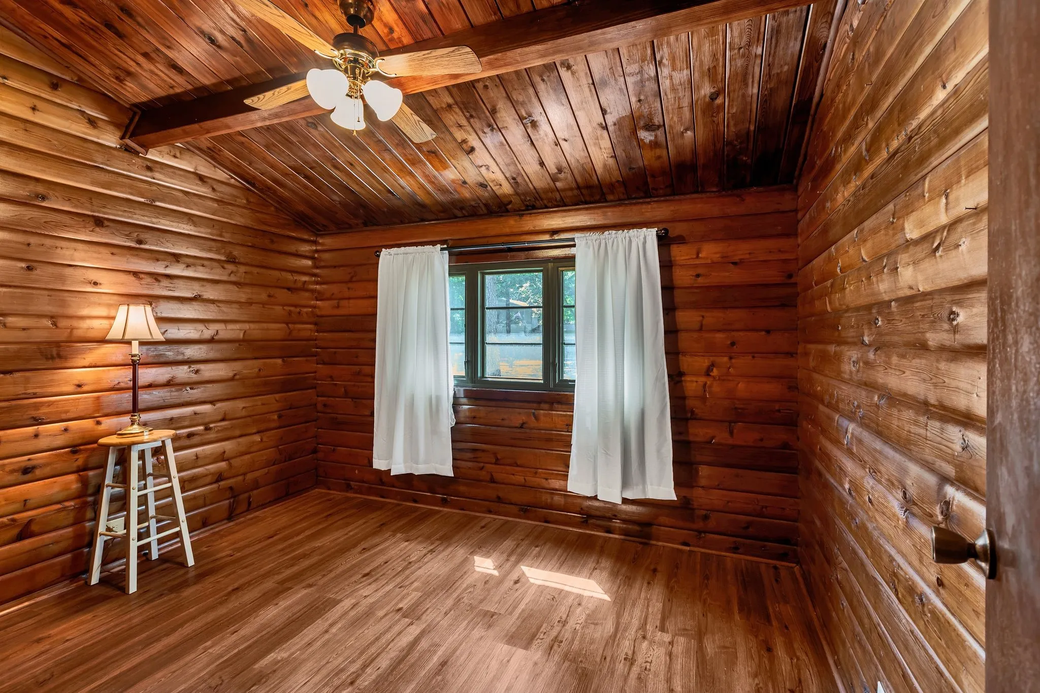 Bedroom featuring wood finished floors, wooden ceiling, and ceiling fan