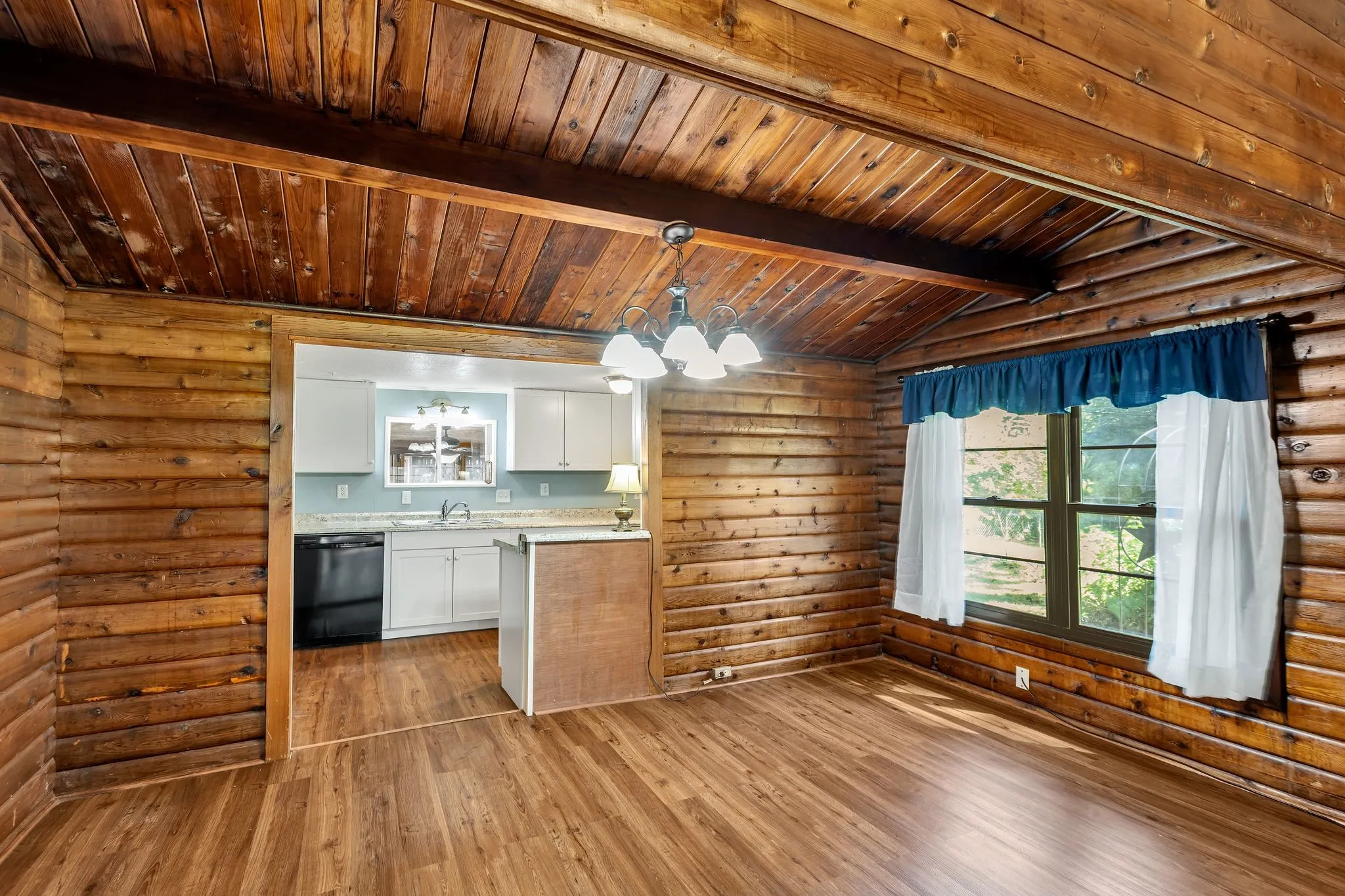 Dining room featuring rustic walls with entrance to kitchen