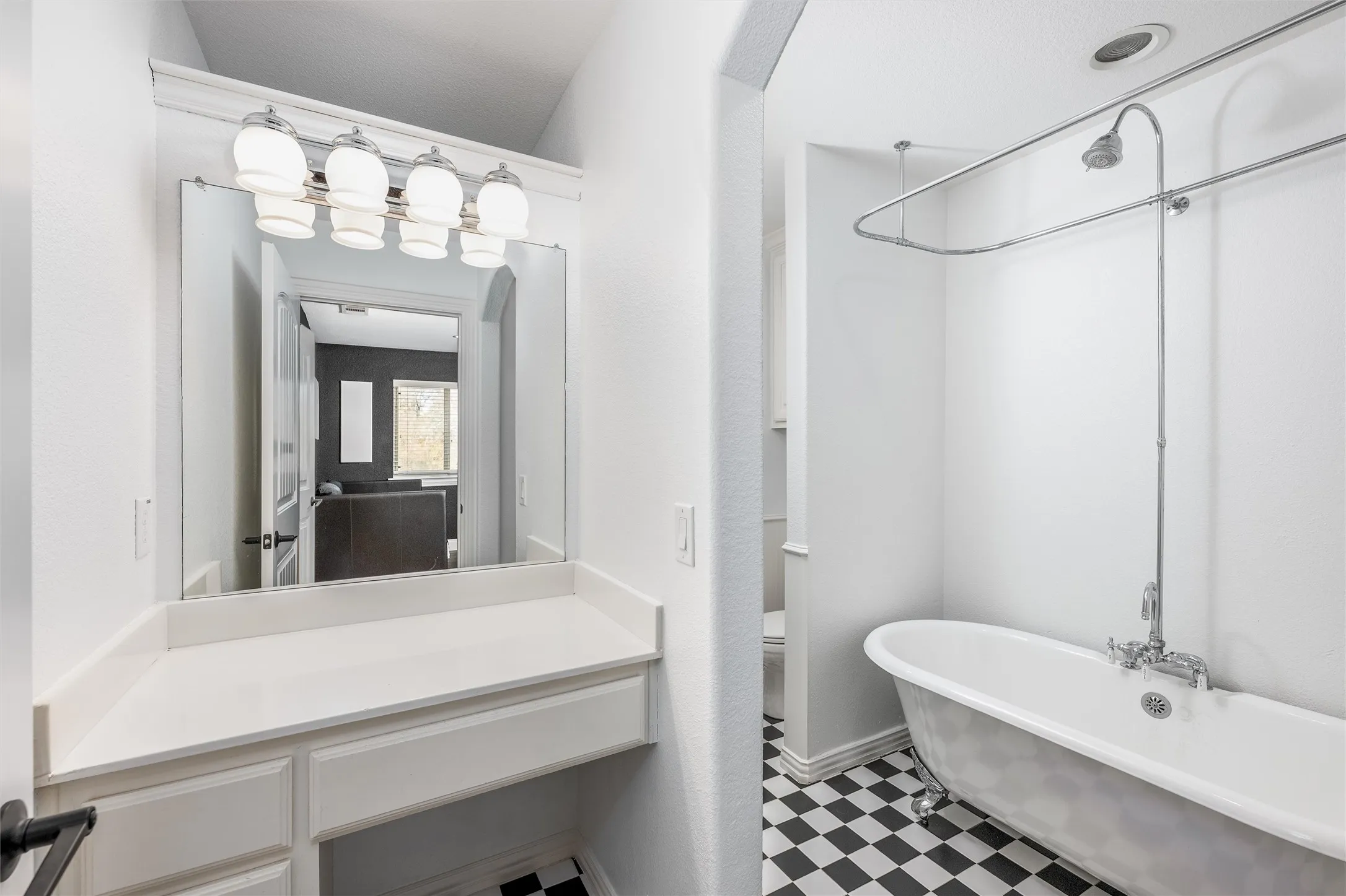 Full bath with tile patterned floors and a combined bath / shower with freestanding tub