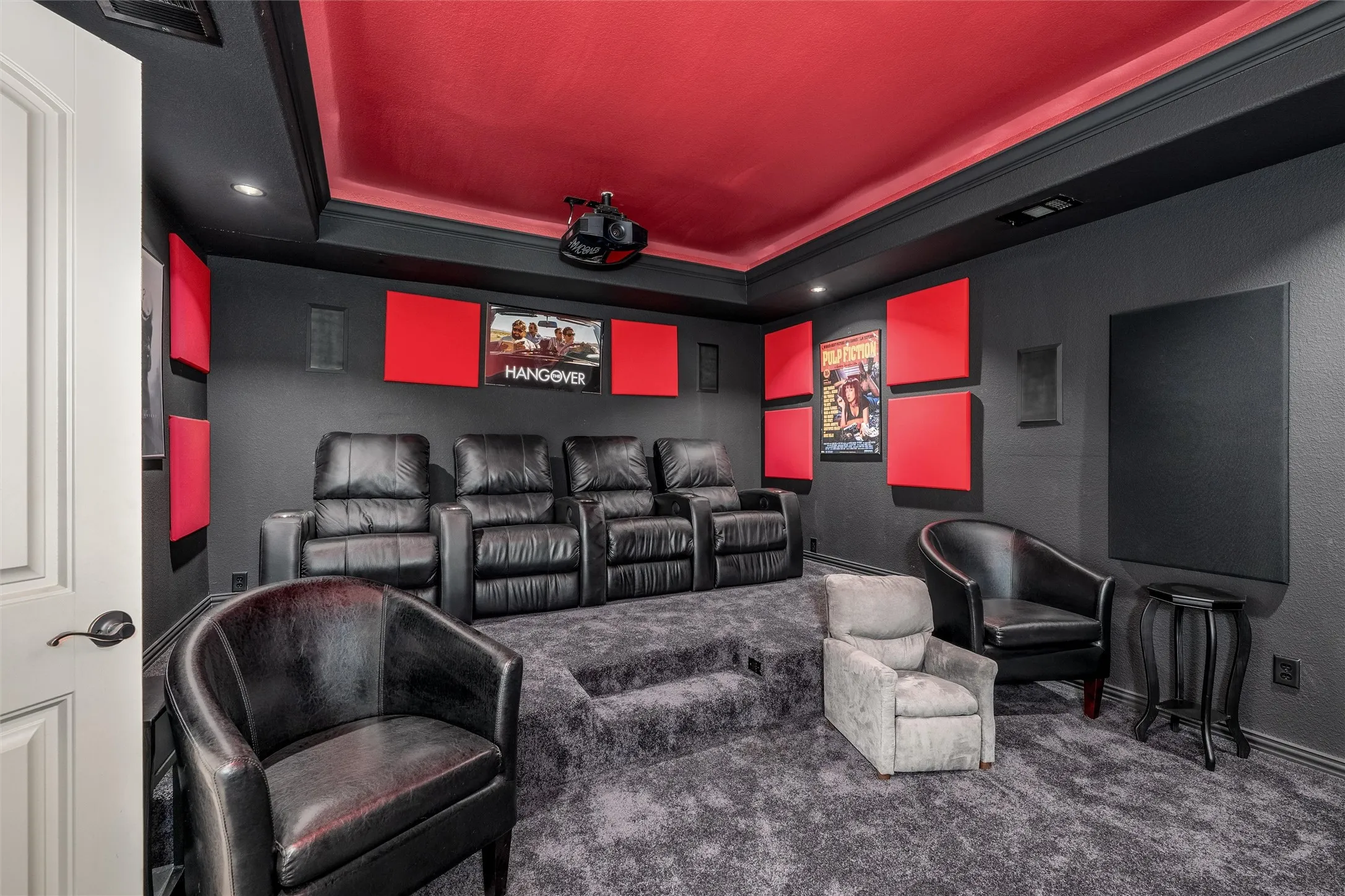 Cinema room featuring carpet floors, a raised ceiling, a textured wall, noise cancelling panels, and recessed lighting