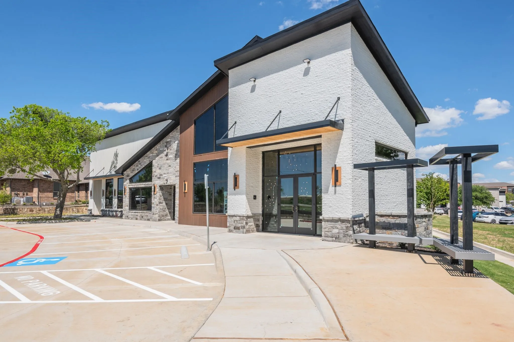 Back of property featuring french doors, a patio area, and stone siding