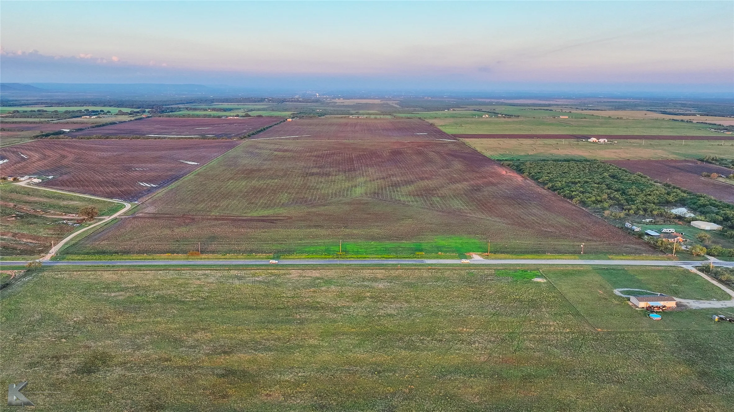 Aerial view of sparsely populated area featuring rows of crops