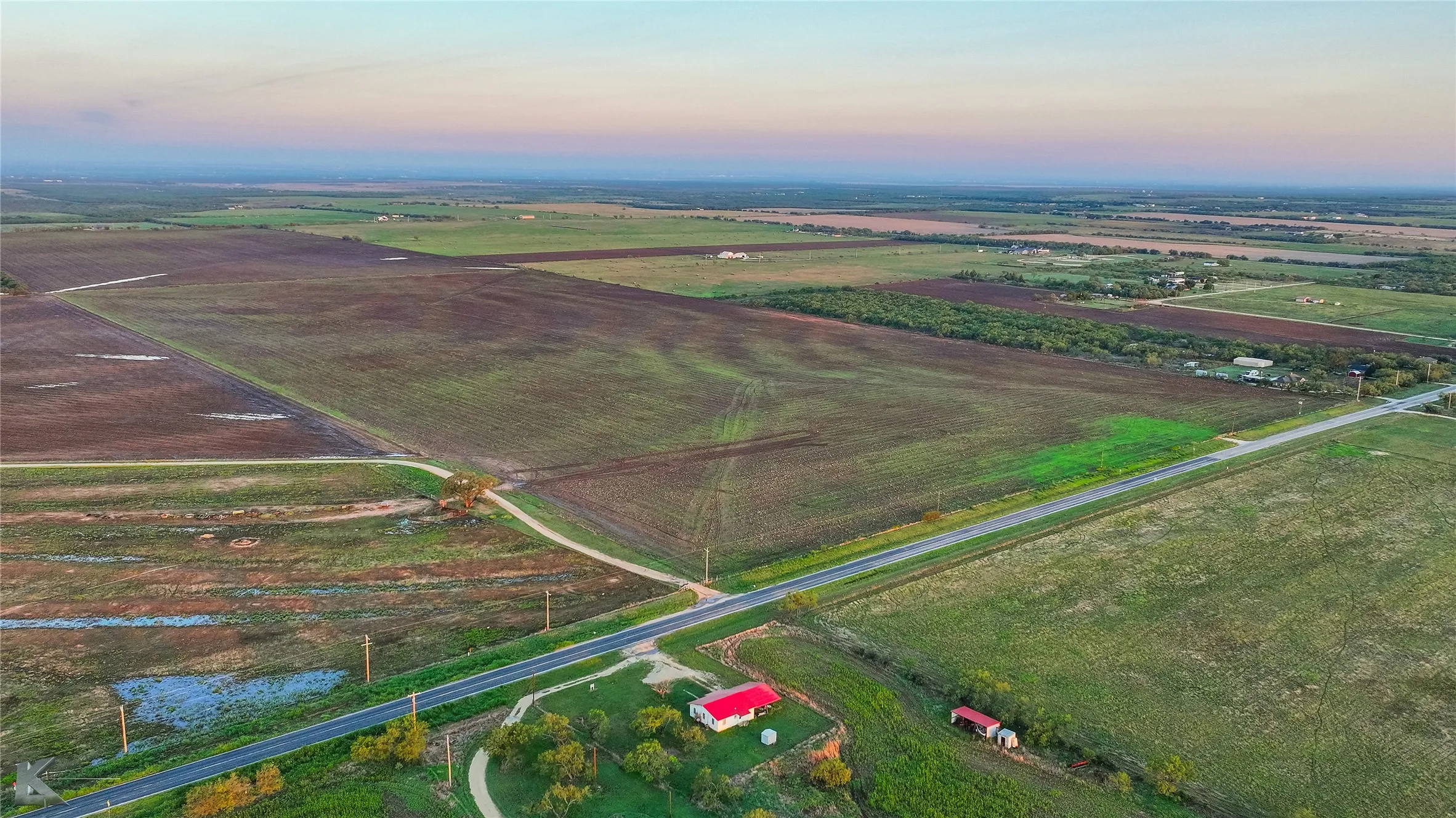 Aerial view of sparsely populated area featuring large plots for crops