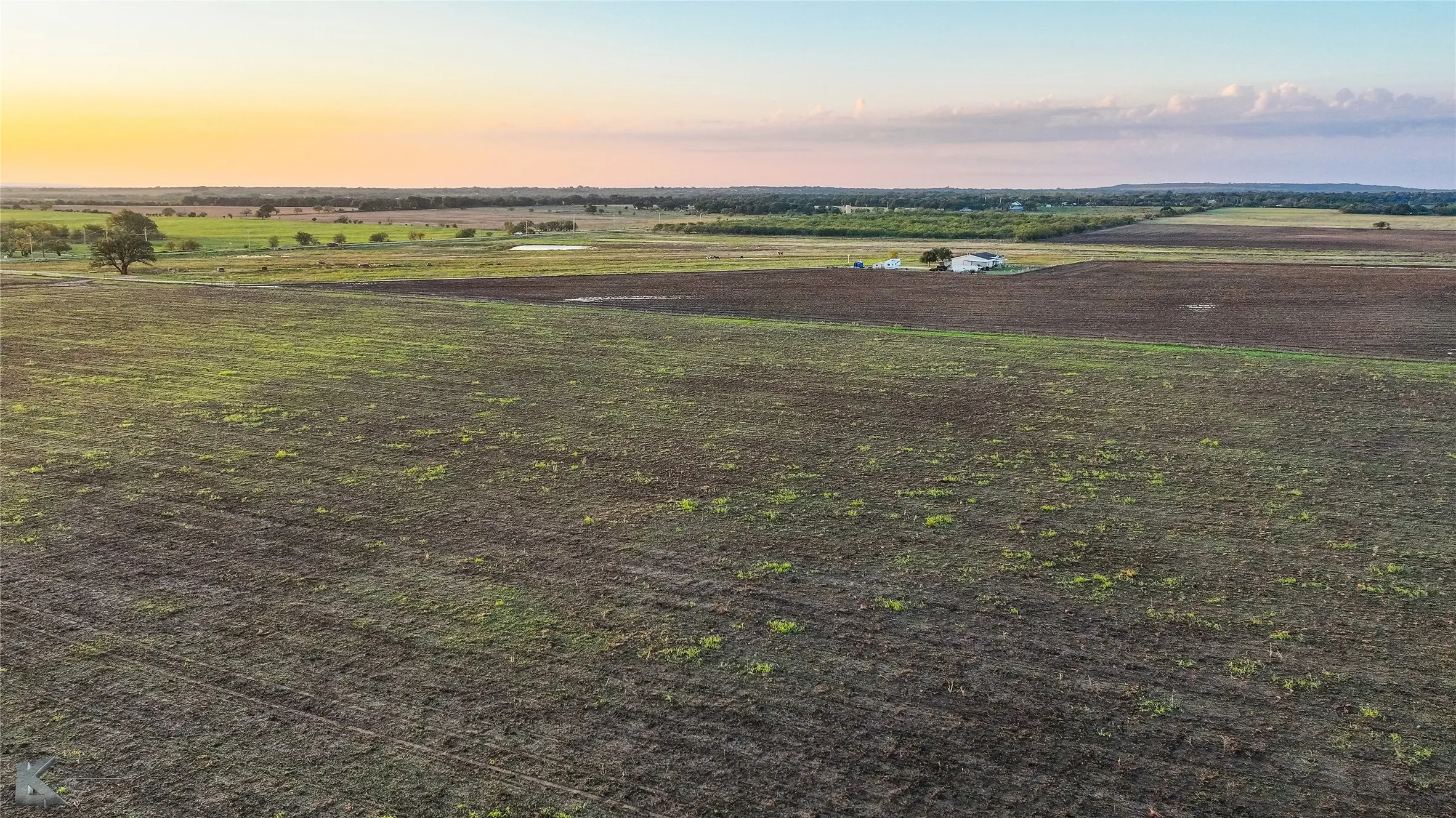 Overview of rural landscape featuring large plots for crops