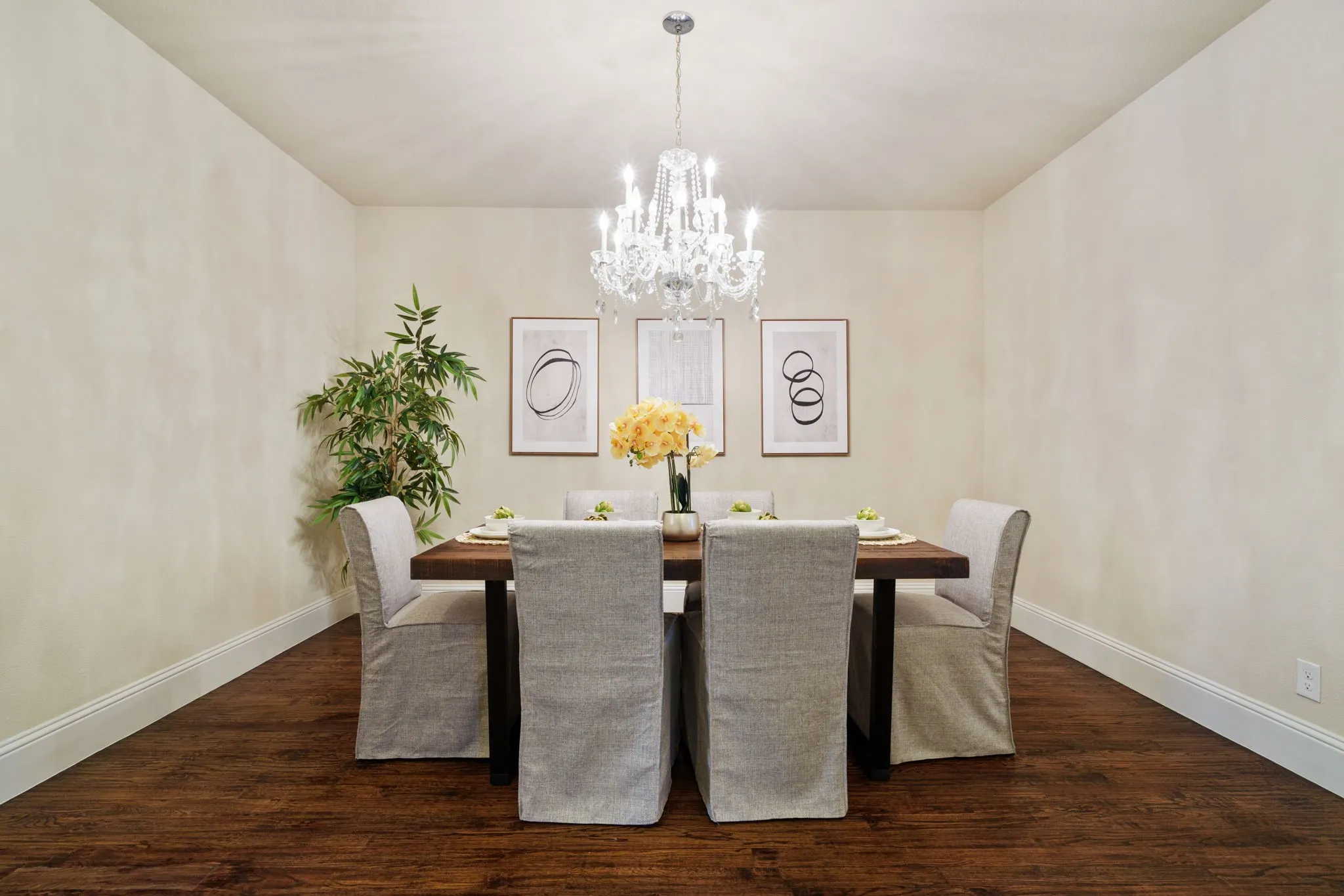 Spacious dining room with hardwood floors and designer lighting, ideal for hosting family dinners and holidays.