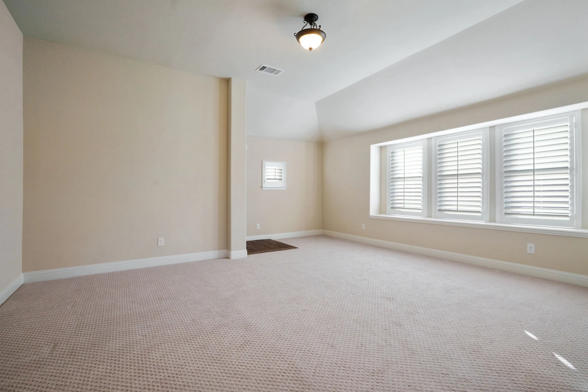 Upstairs game room with a wall of windows and natural light