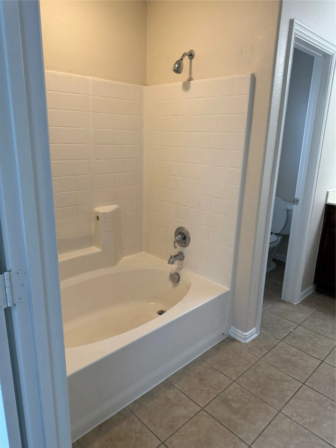 Full bath featuring light tile patterned floors, shower / tub combination, and vanity