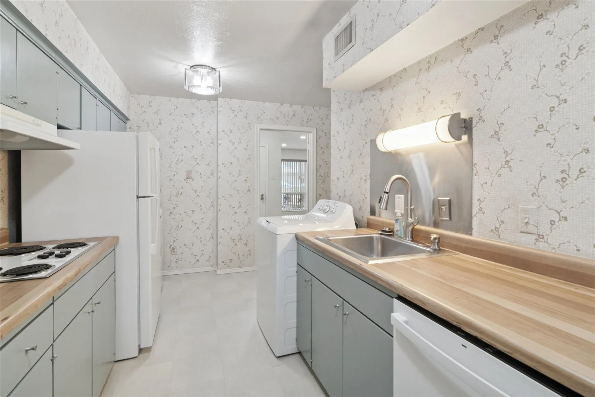 New counter tops, sink, stove top, refrigerator washer and dryer, flooring and lighting!
