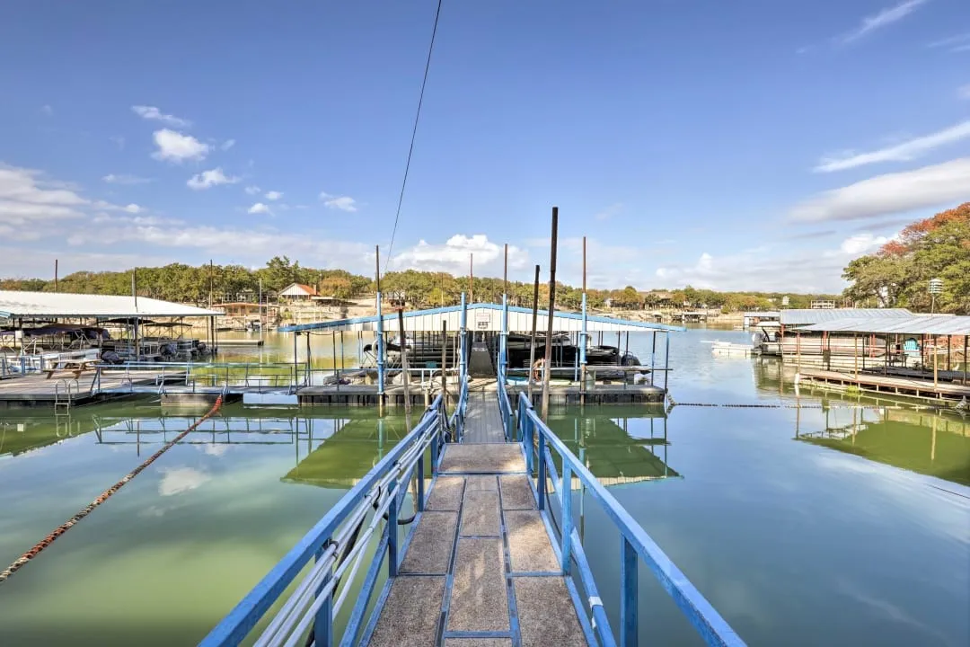 Dock area featuring a water view and view of wooded area