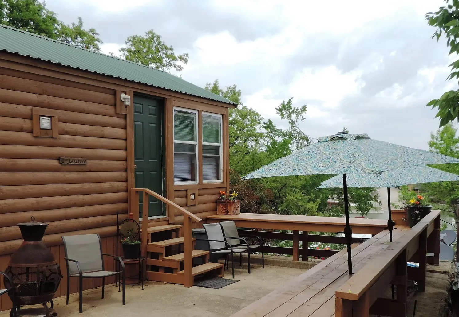 Wooden terrace featuring entry steps and a patio area