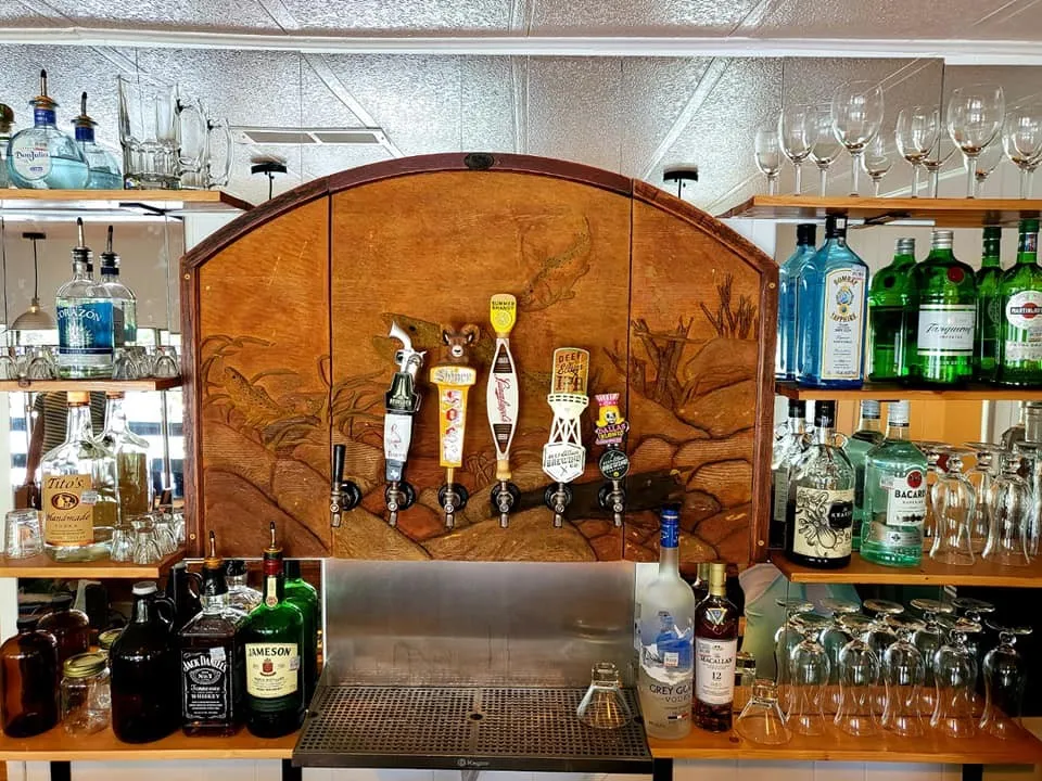 Indoor dry bar featuring crown molding