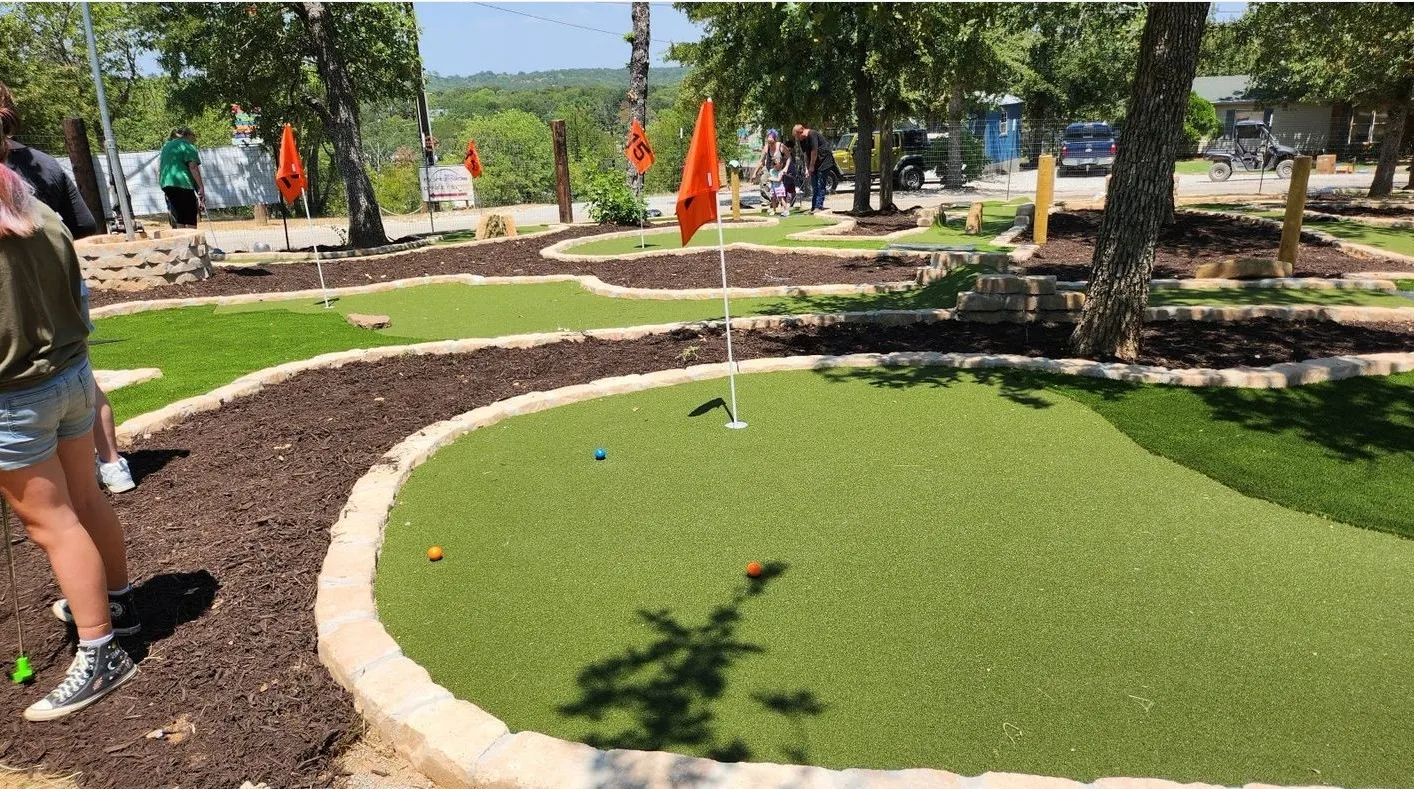 View of property's community with a putting area