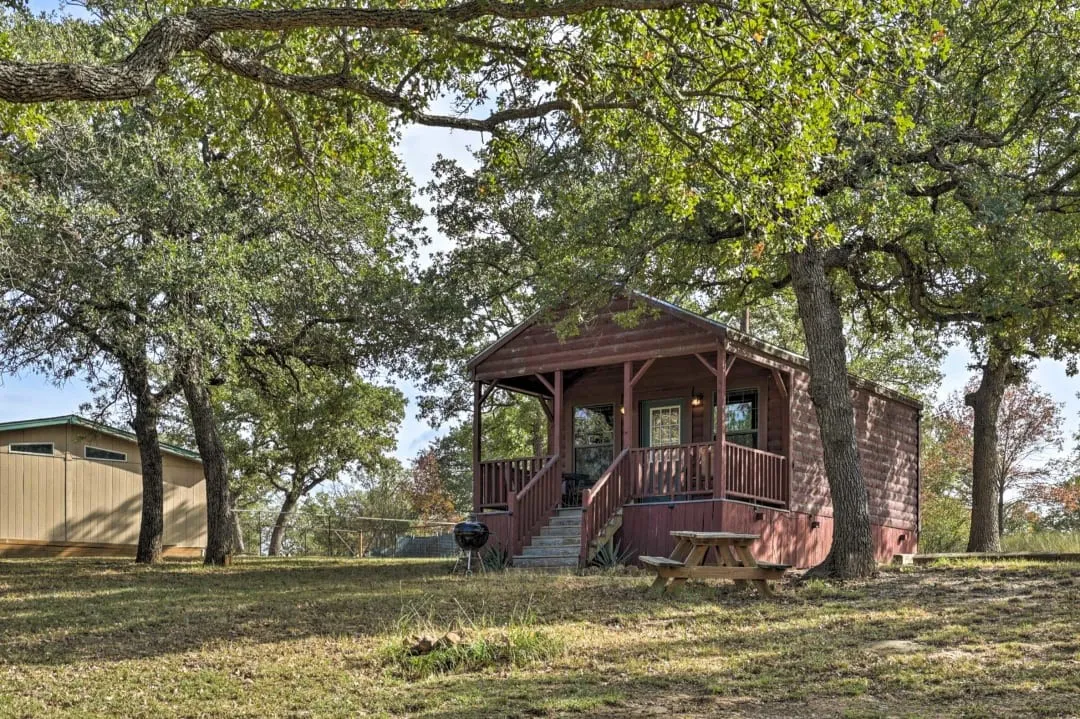 Chalet / cabin with a front lawn and covered porch