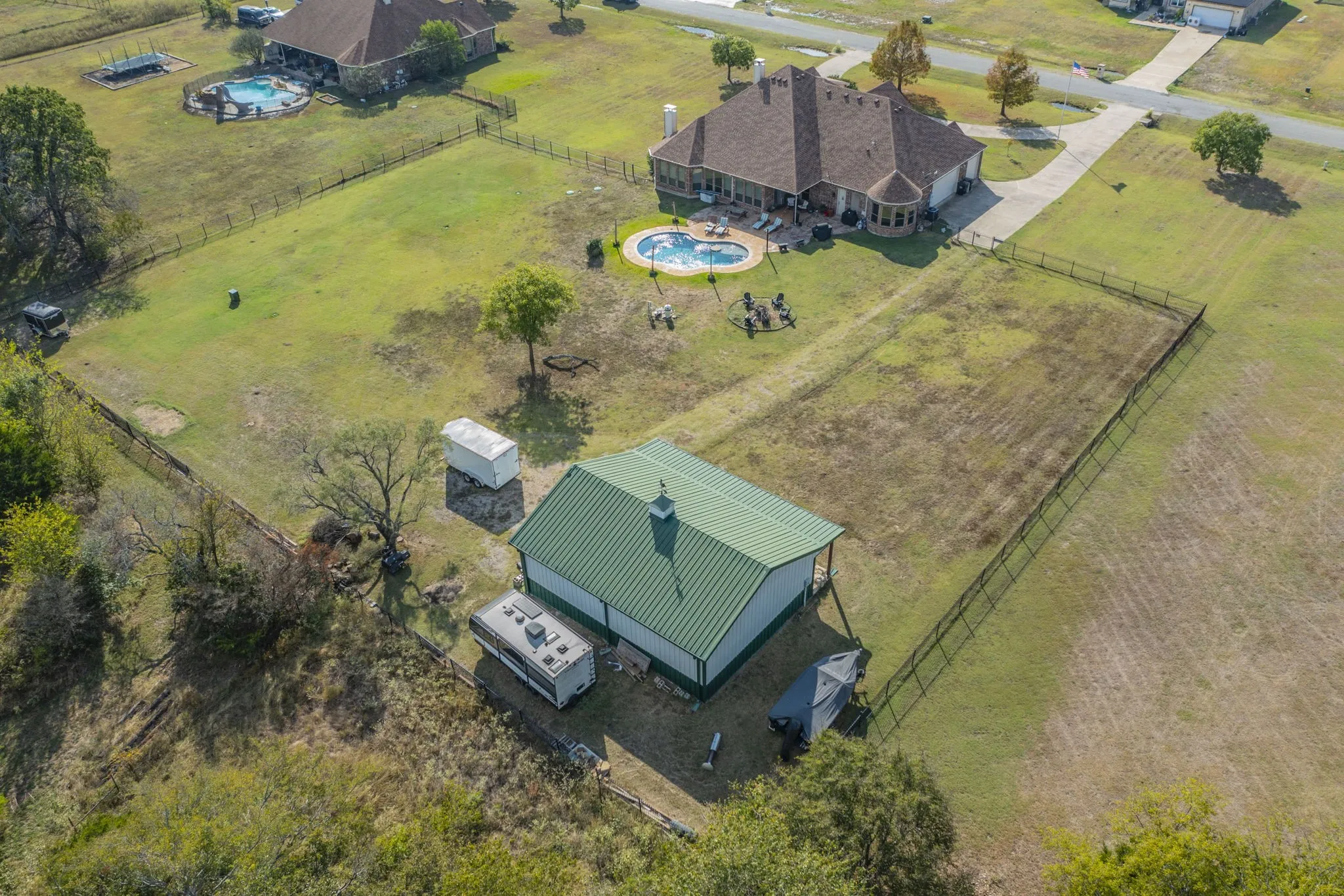 View of rural area featuring a pool and a pastoral area