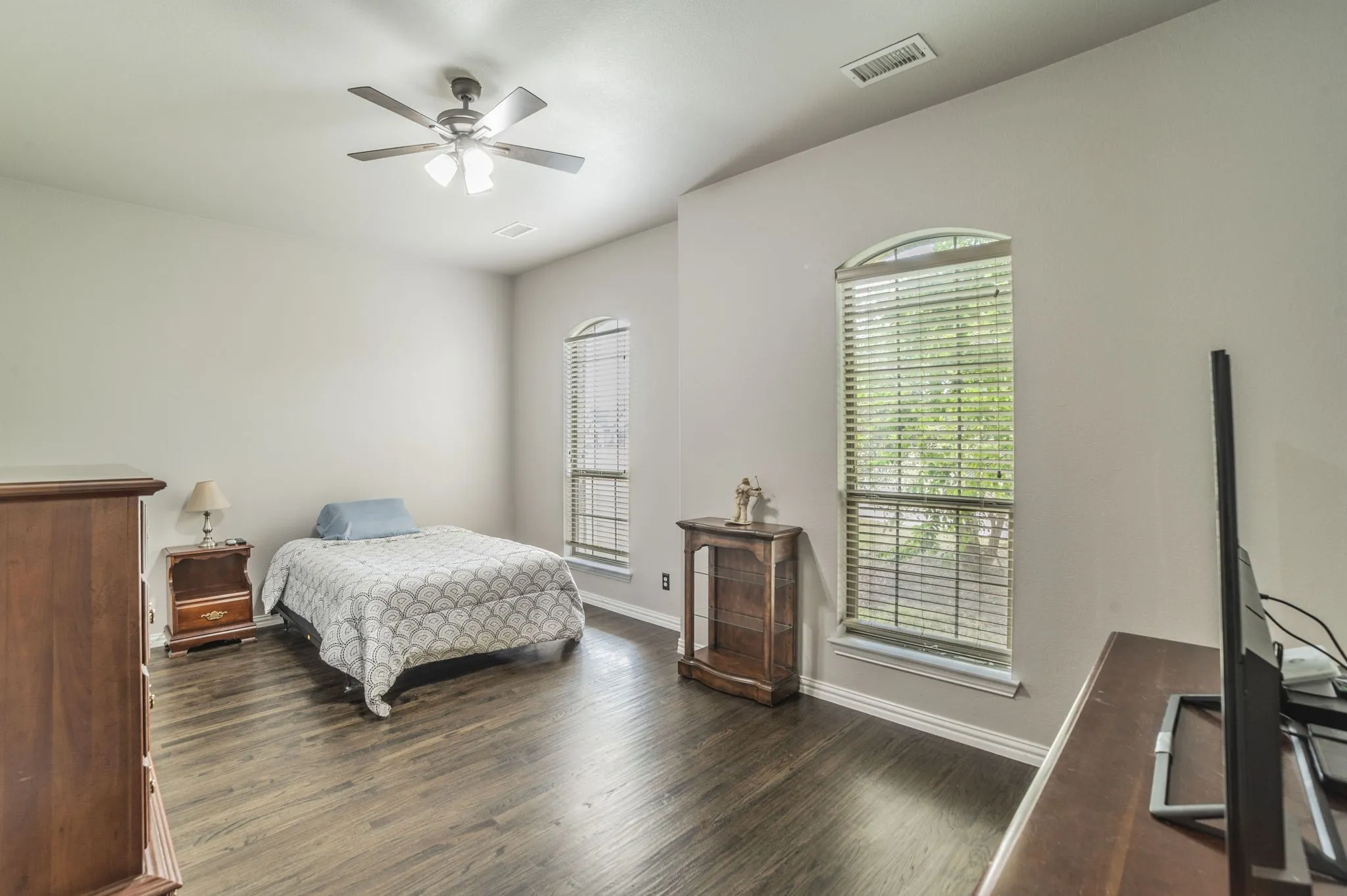 Bedroom featuring dark wood-style floors and a ceiling fan
