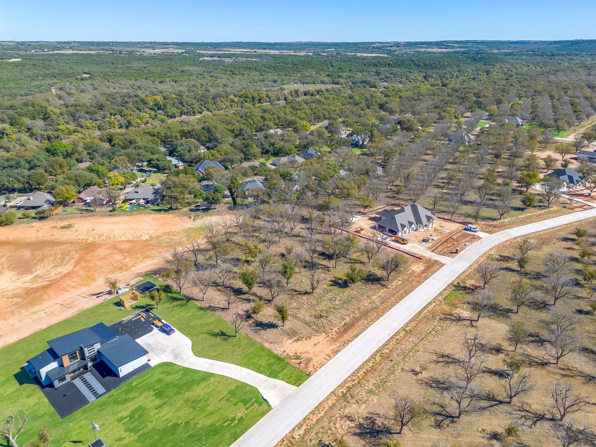 Aerial view of property's location with nearby suburban area