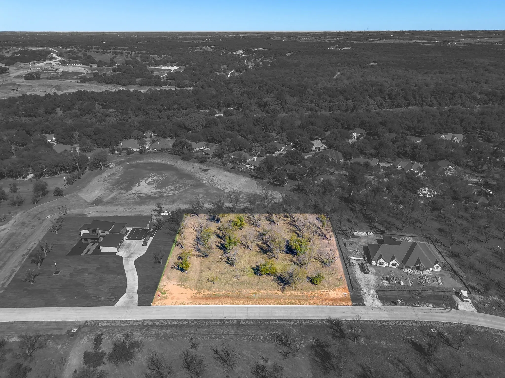 Aerial view of property and surrounding area with property parcel outlined