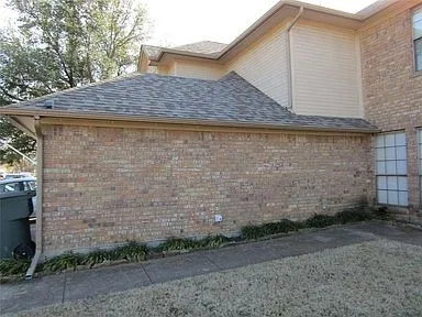 View of property exterior with brick siding