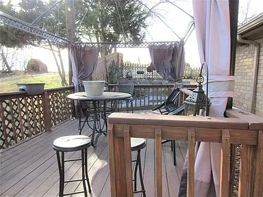 Deck with outdoor dining space and a gazebo