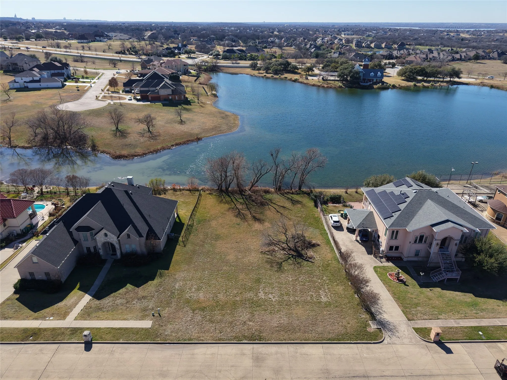 Aerial view of residential area featuring a large body of water