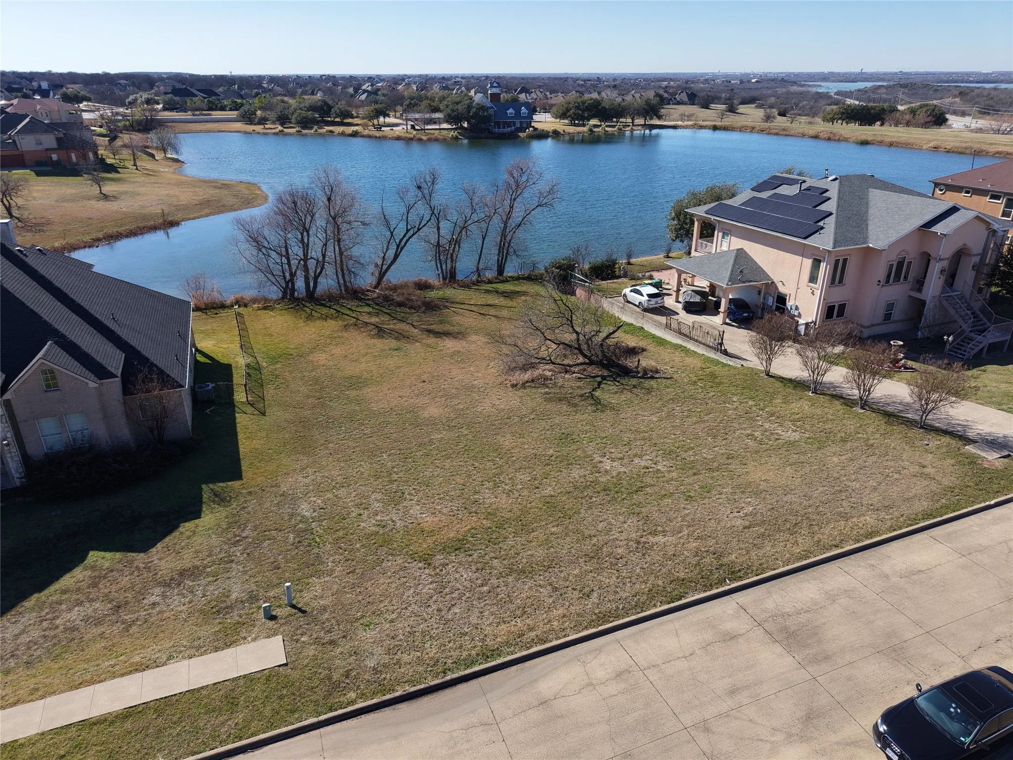Aerial view of property and surrounding area featuring a nearby body of water