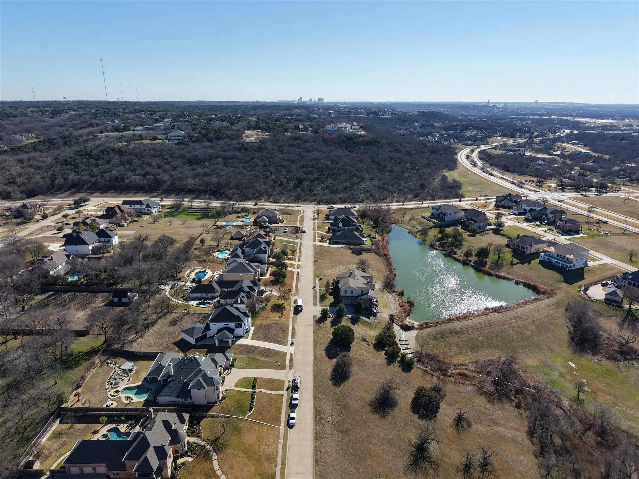 Aerial view of property's location with a nearby body of water and nearby suburban area