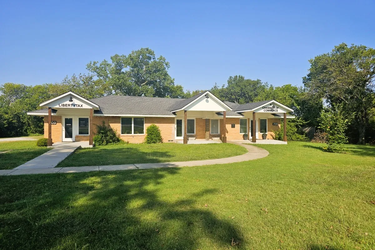 View of front of house featuring brick siding and a front yard