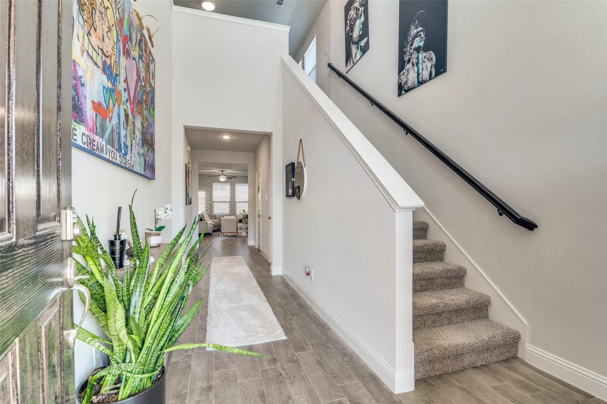 Foyer entrance with wood finish floors, a high ceiling, stairway, recessed lighting, and a ceiling fan