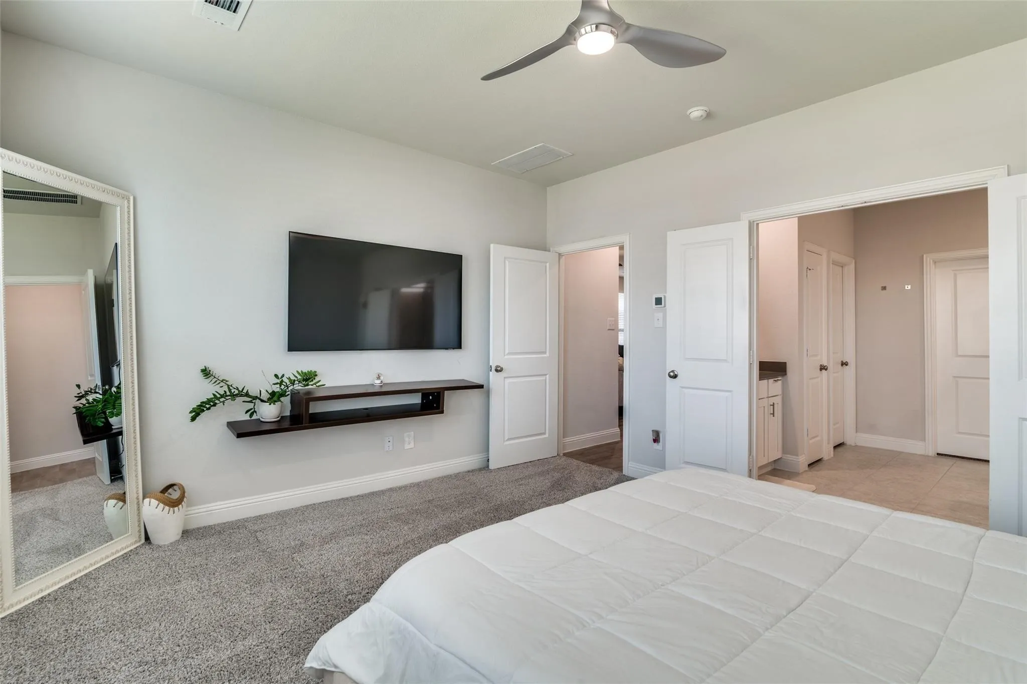 Bedroom with light carpet and ceiling fan