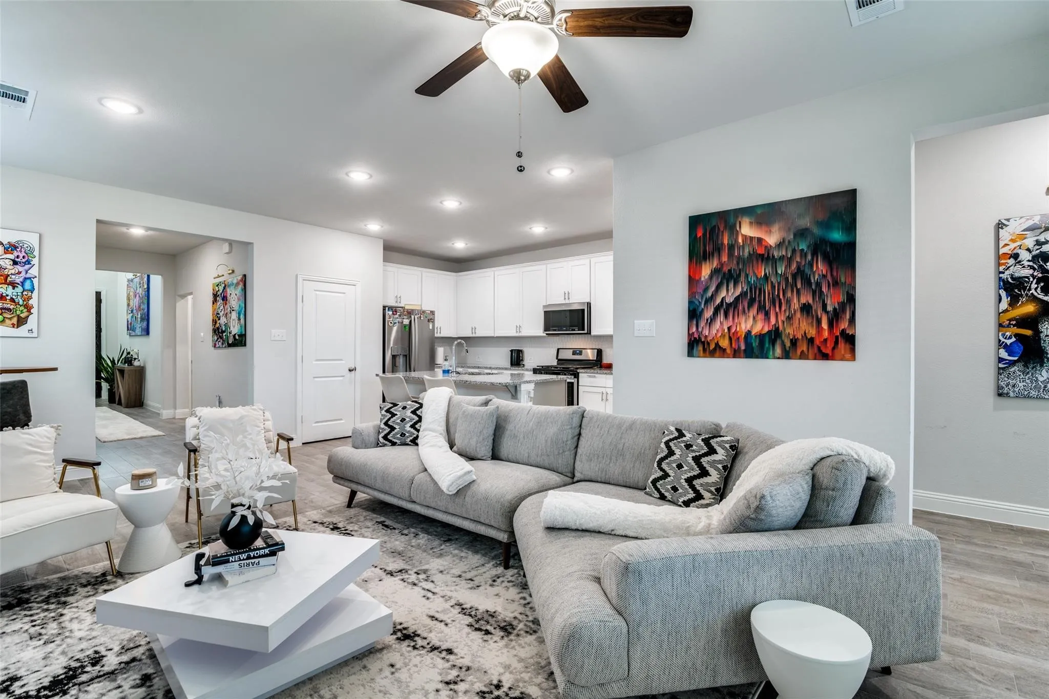Living area with recessed lighting, ceiling fan, and light wood finished floors