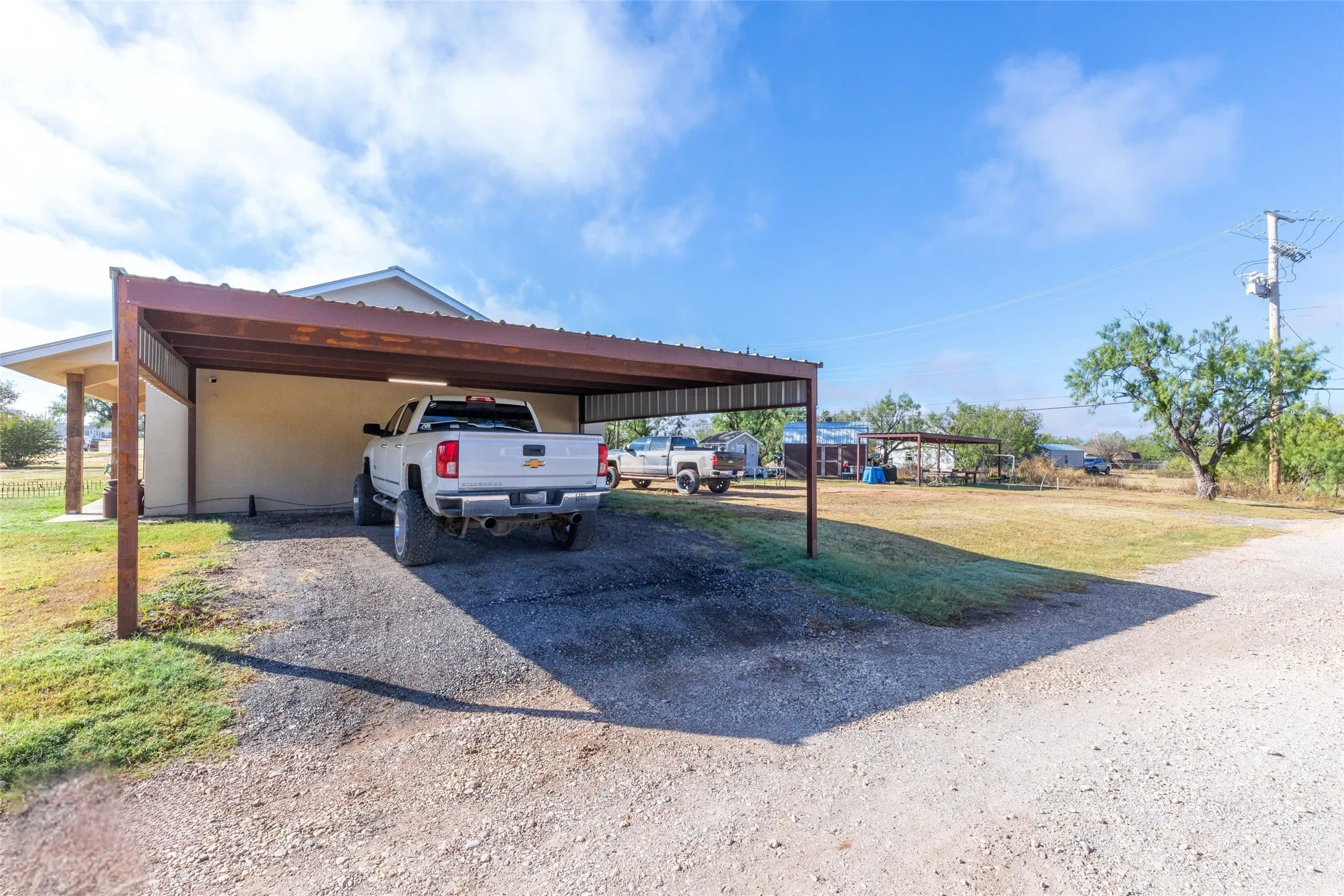 Covered detached carport on larger corner lot
