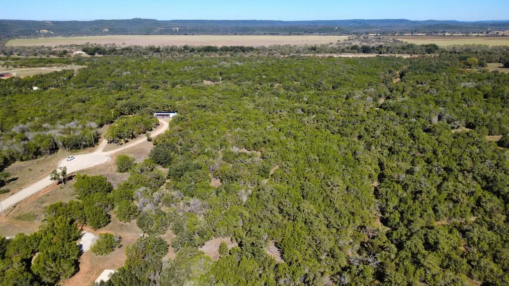 Aerial overview of property's location featuring a heavily wooded area