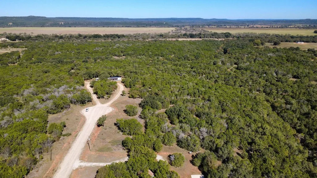 Aerial overview of property's location with a forest