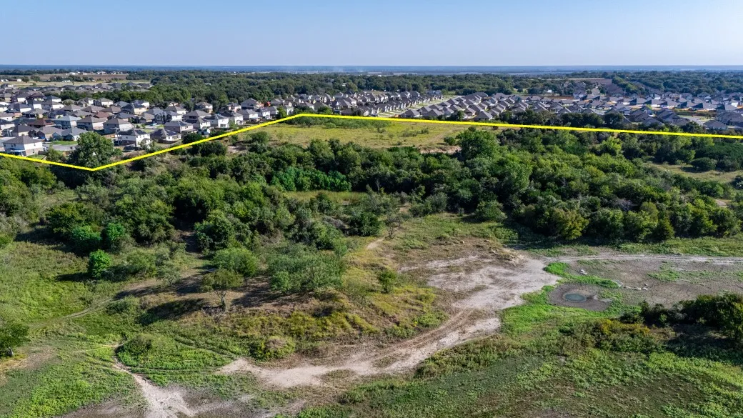 Aerial view of residential area with property boundaries highlighted