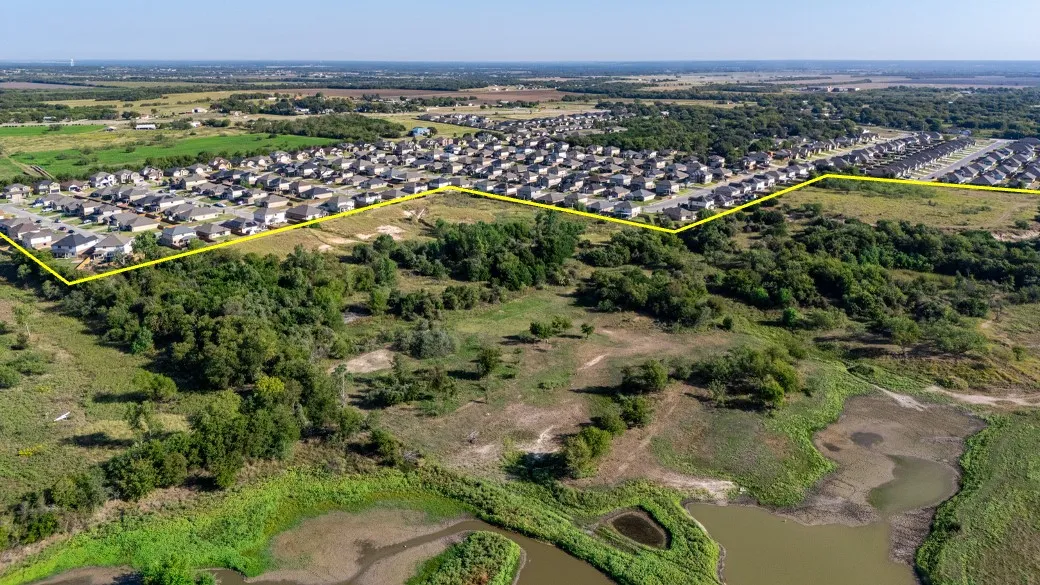 Aerial perspective of suburban area with property parcel outlined