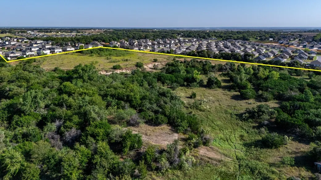 Aerial view of residential area with property parcel outlined