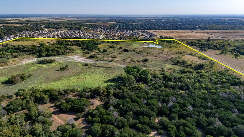 Aerial view of sparsely populated area with property boundaries highlighted