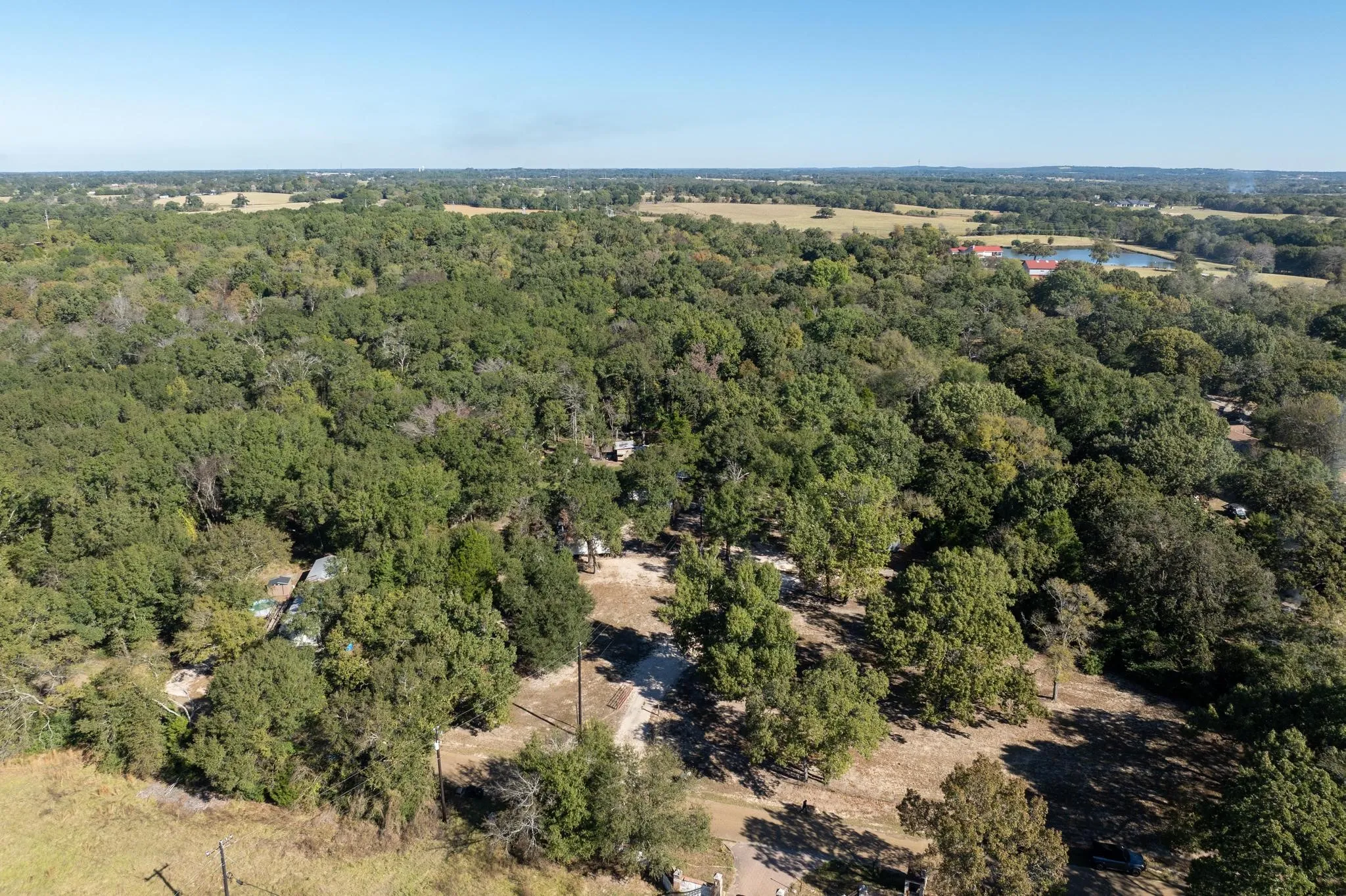 Aerial overview of property's location featuring a heavily wooded area