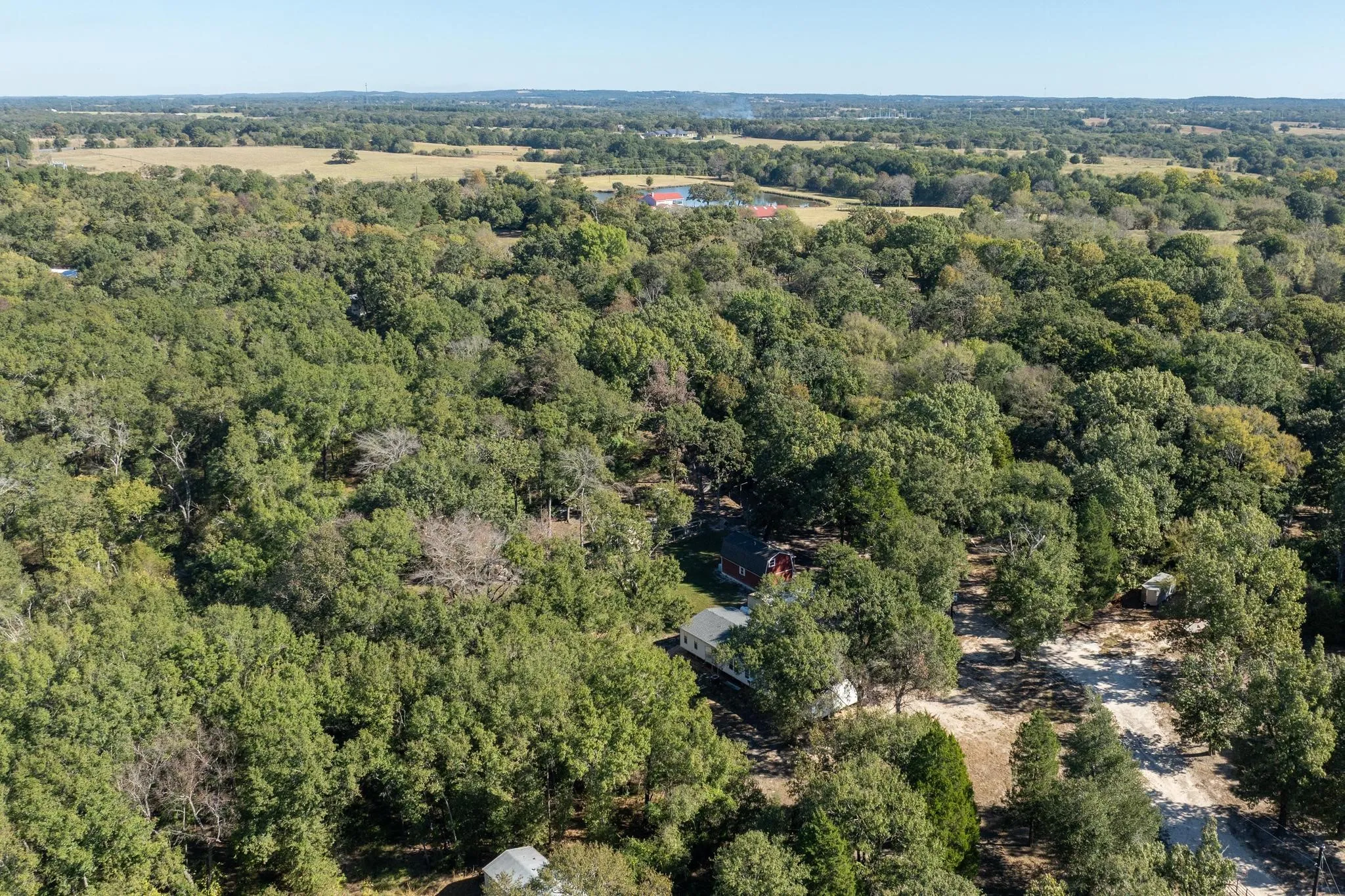 Aerial view of property's location featuring a heavily wooded area