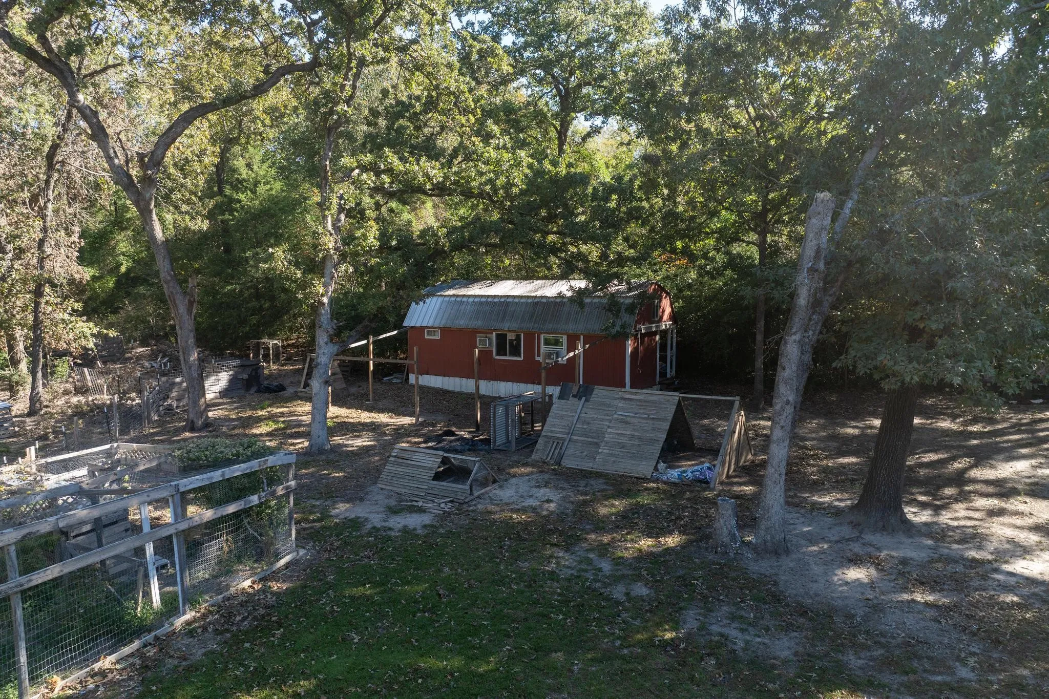 View of yard featuring an outbuilding and a view of trees