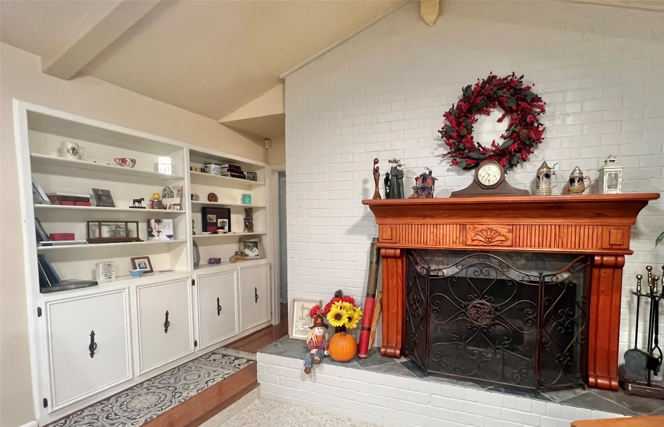 Great room.  Beautiful fireplace and built-in shelving.  The custom cover stays with the fireplace.