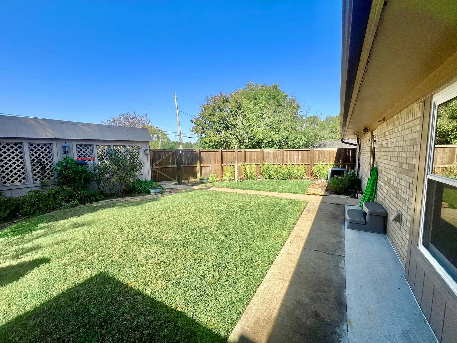 View of North half of back yard.  Plenty of grassy area for children and pets to play.