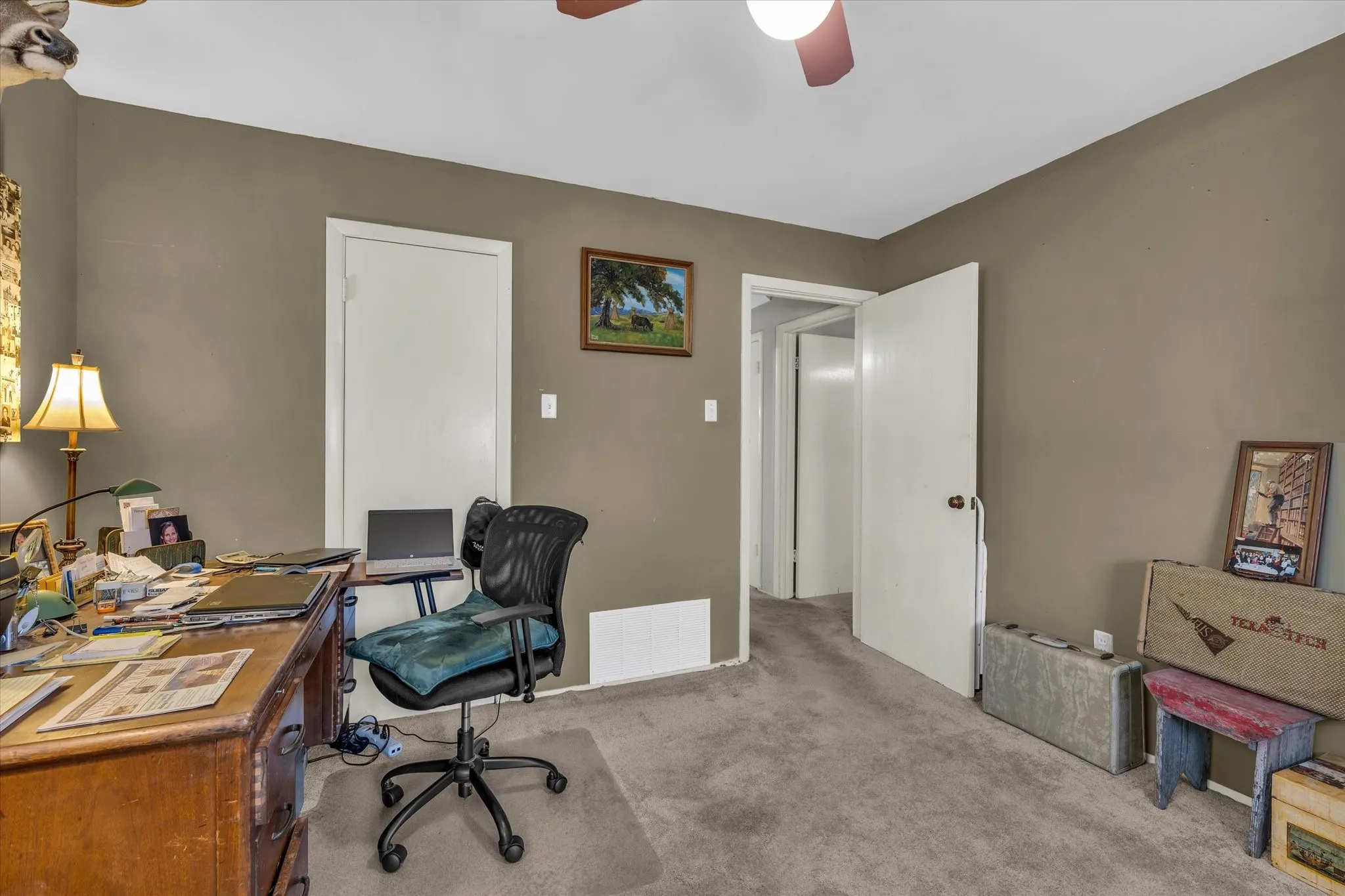 Office area featuring ceiling fan and light colored carpet