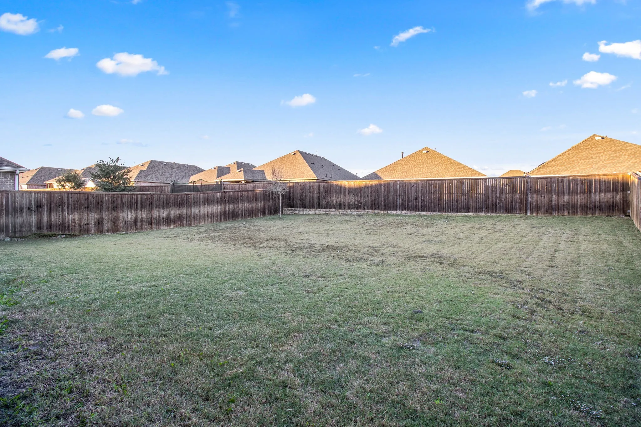 Fenced backyard with a residential view