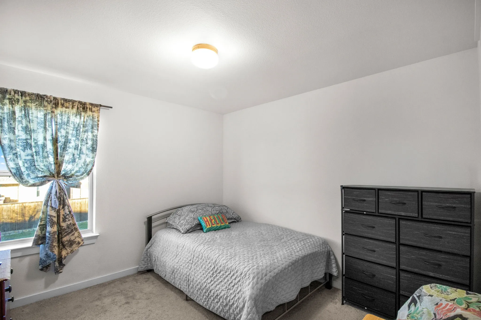 Bedroom featuring carpet flooring and baseboards