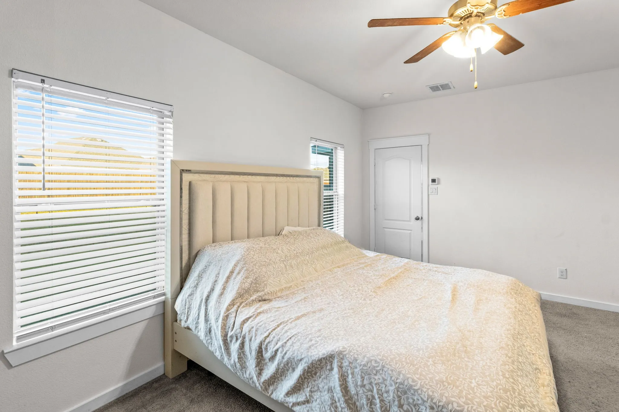 Bedroom featuring carpet and a ceiling fan