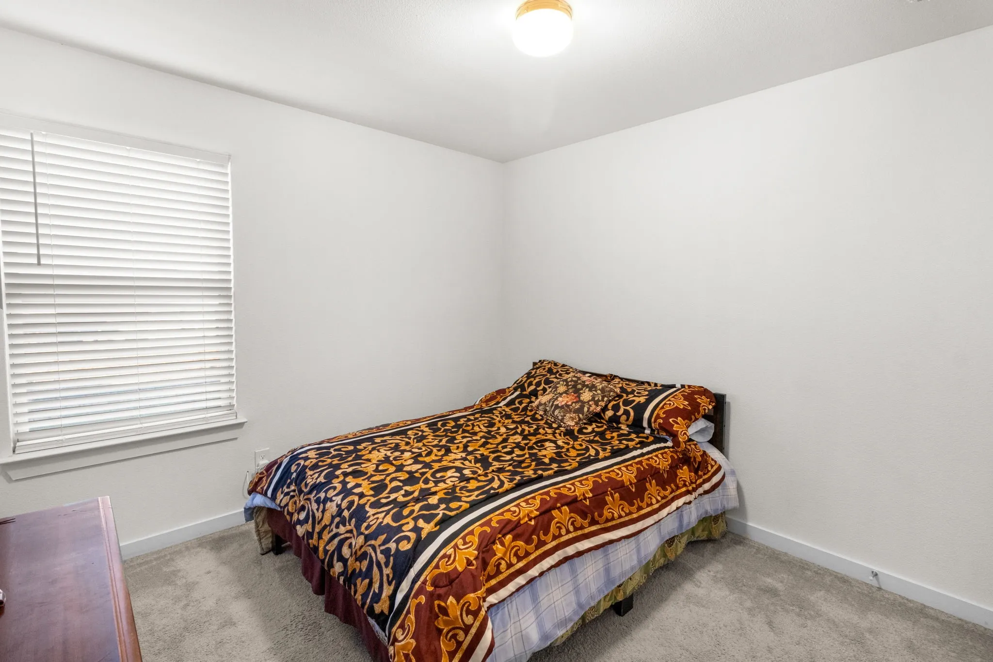Carpeted bedroom with baseboards