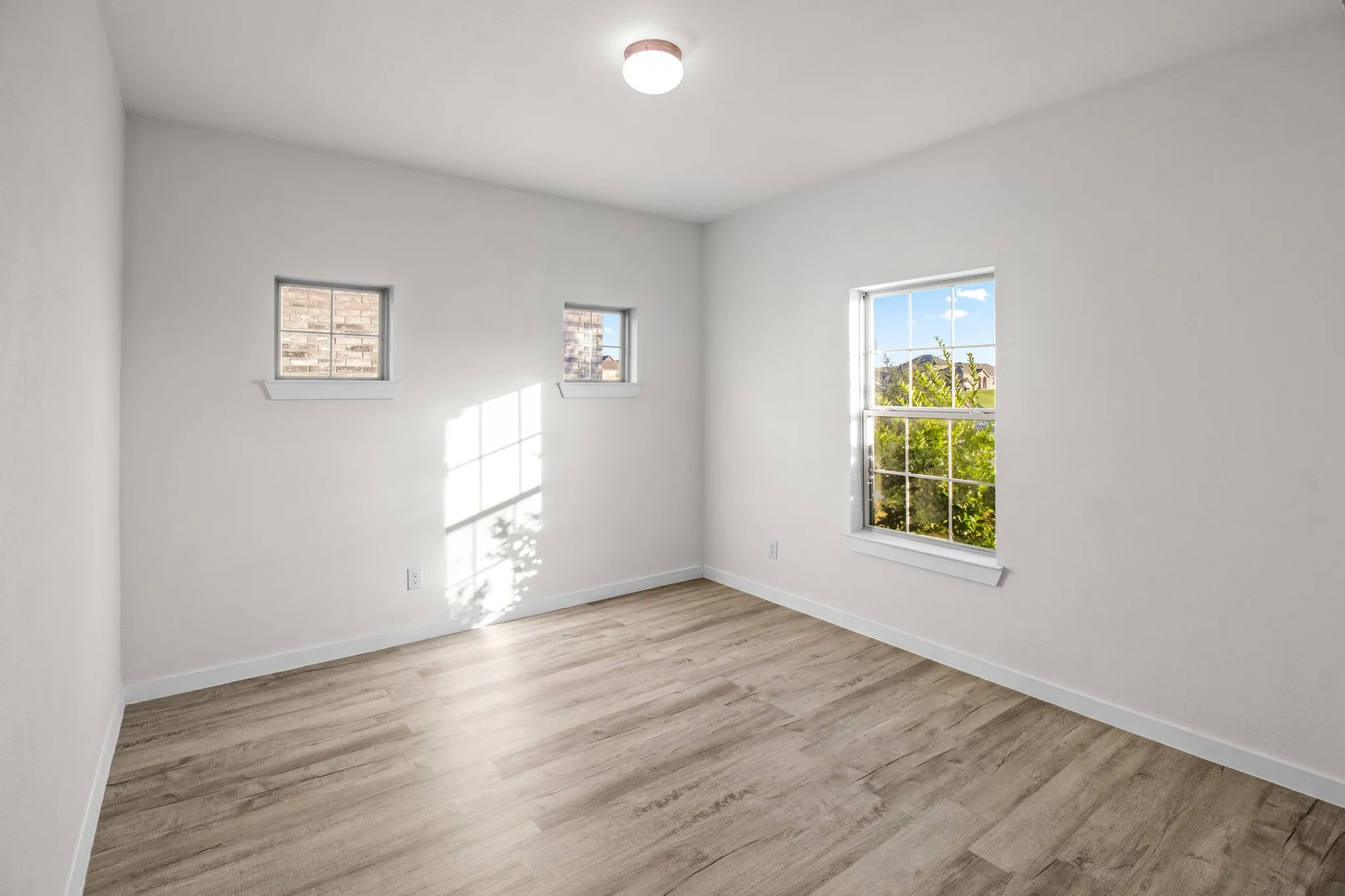 Empty room featuring light wood-type flooring